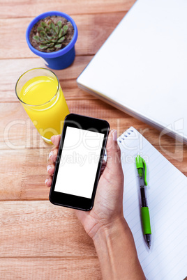 Overhead of feminine hands holding smartphone