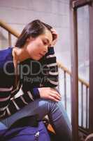 Worried student sitting in hallway