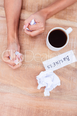 Businesswoman holding crumpled paper