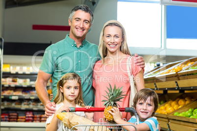 Young Family posing together with trolley