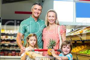 Young Family posing together with trolley