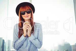 Smiling hipster woman drinking coffee
