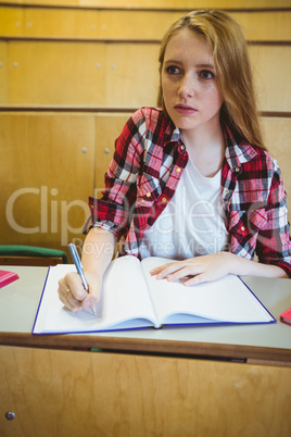 Focused student taking notes during class