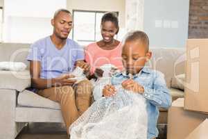 Family unwrapping things in new home