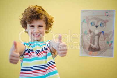 Boy holding his thumbs up