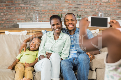 Happy family taking a picture on the couch