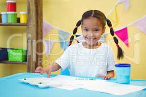 Smiling girl who is finger painting
