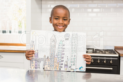 Smiling boy showing his drawing