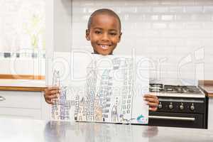 Smiling boy showing his drawing