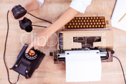 Above view of typewriter and old phone