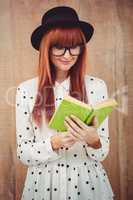 Hipster woman reading a green book