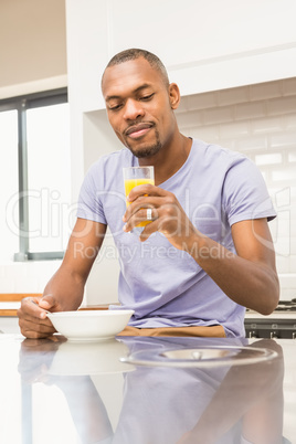 Casual happy man having breakfast