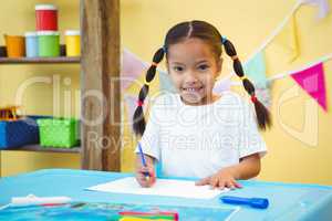 Smiling girl writing on some paper
