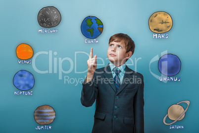 Teenage boy in a serious suit points a finger of the planet of t