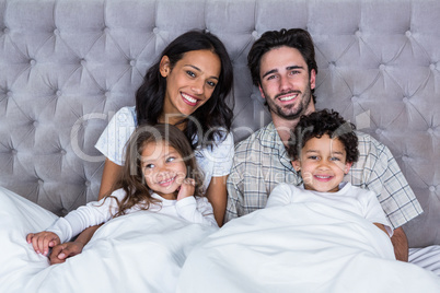 Happy family on the bed