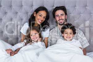 Happy family on the bed