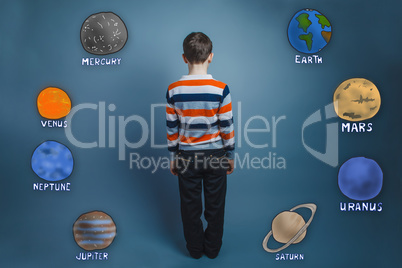 Teenage boy standing with his back planets of the solar system a