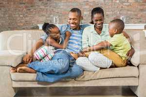 Happy family posing on the couch together