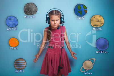 Teenage girl in headphones surprised furrowed face of the planet