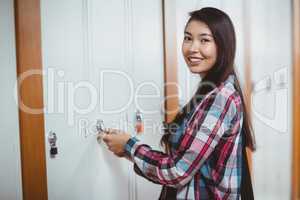 Smiling student opening locker