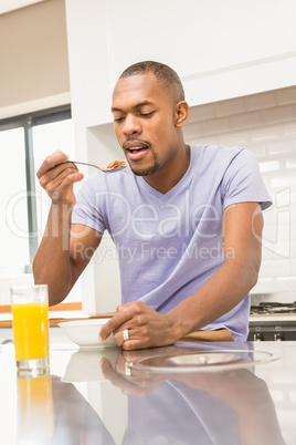 Casual happy man having breakfast