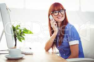 Smiling hipster woman on phone