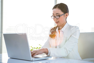 Smiling woman using her laptop