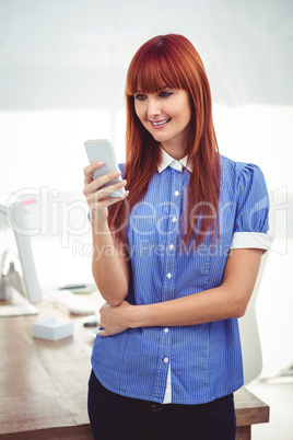 Smiling hipster woman using smartphone