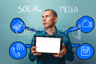 man holding tablet in hand and looks in the direction of social