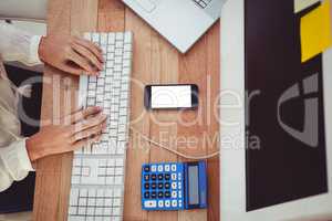 Cropped image of woman typing on keyboard