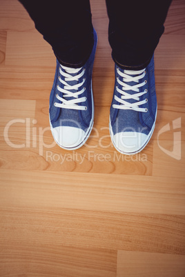 Cropped image of woman wearing sneakers