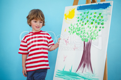 Happy boy painting his picture