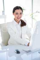 Smiling businesswoman using her computer