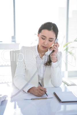 Smiling businesswoman using her telephone