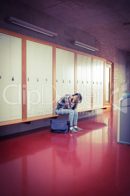 Worried student sitting with hands on head