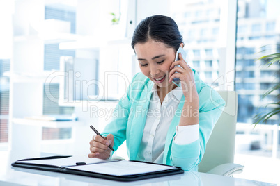 Happy businesswoman sitting down