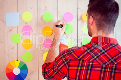 Creative worker using wall for brainstorm Creative worker using wall for brainstorm