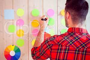 Creative worker using wall for brainstorm