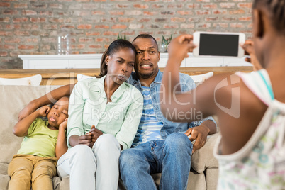 Happy family taking a picture on the couch