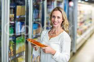 Side view of smiling woman holding food