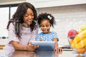 Mother and daughter using tablet pc