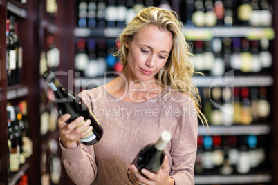 Woman holding bottles of wine