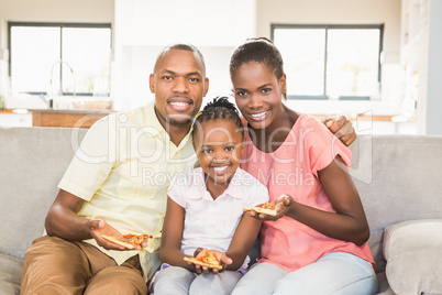 Portrait of a family of three watching tv