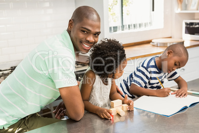 Father with children in the kitchen