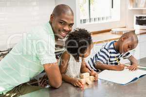 Father with children in the kitchen