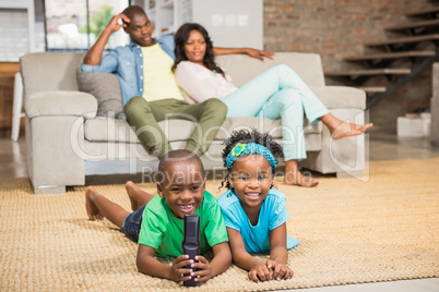 Happy siblings lying on the floor