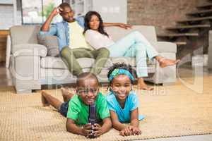 Happy siblings lying on the floor