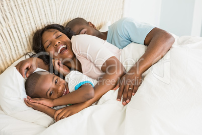 Pretty couple with his son in bed together