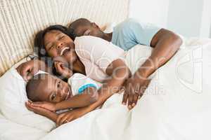 Pretty couple with his son in bed together