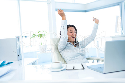 Happy businesswoman gesturing victory